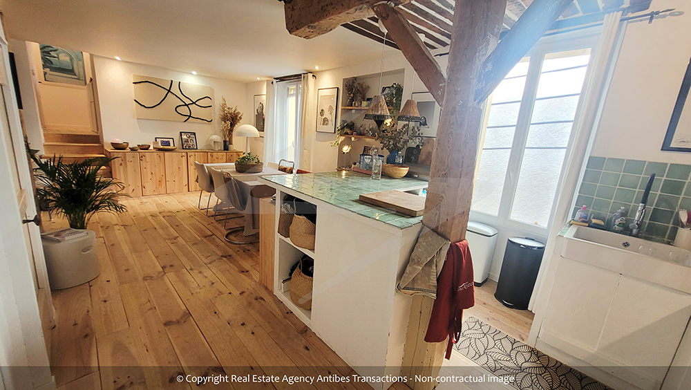 view of the open kitchen and the dining area of the flat